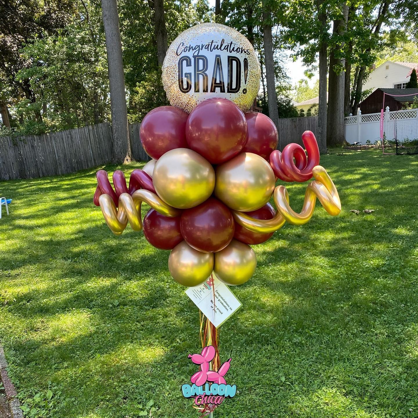 a bunch of balloons are sitting on top of a grass covered field