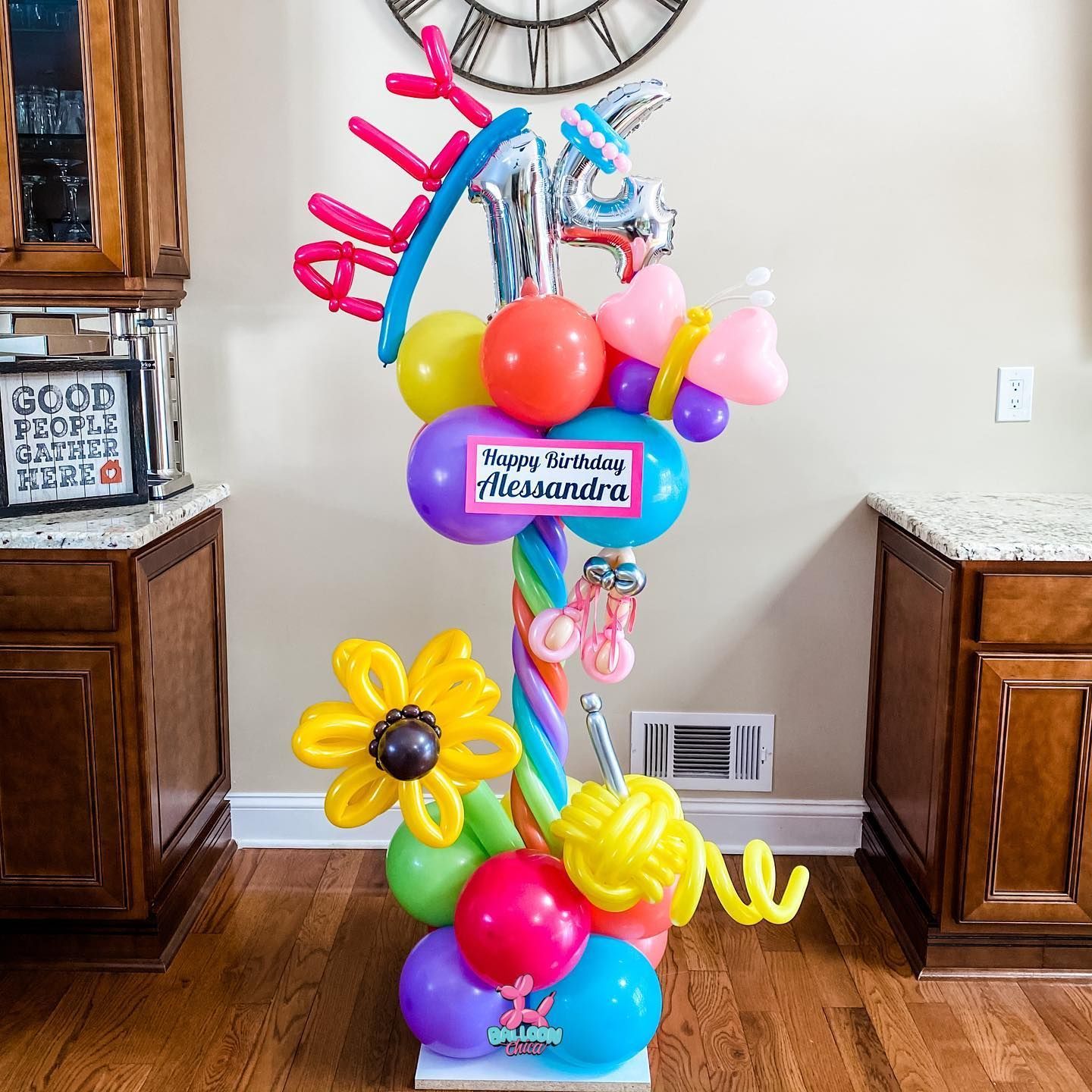 a bunch of colorful balloons are sitting on a wooden floor