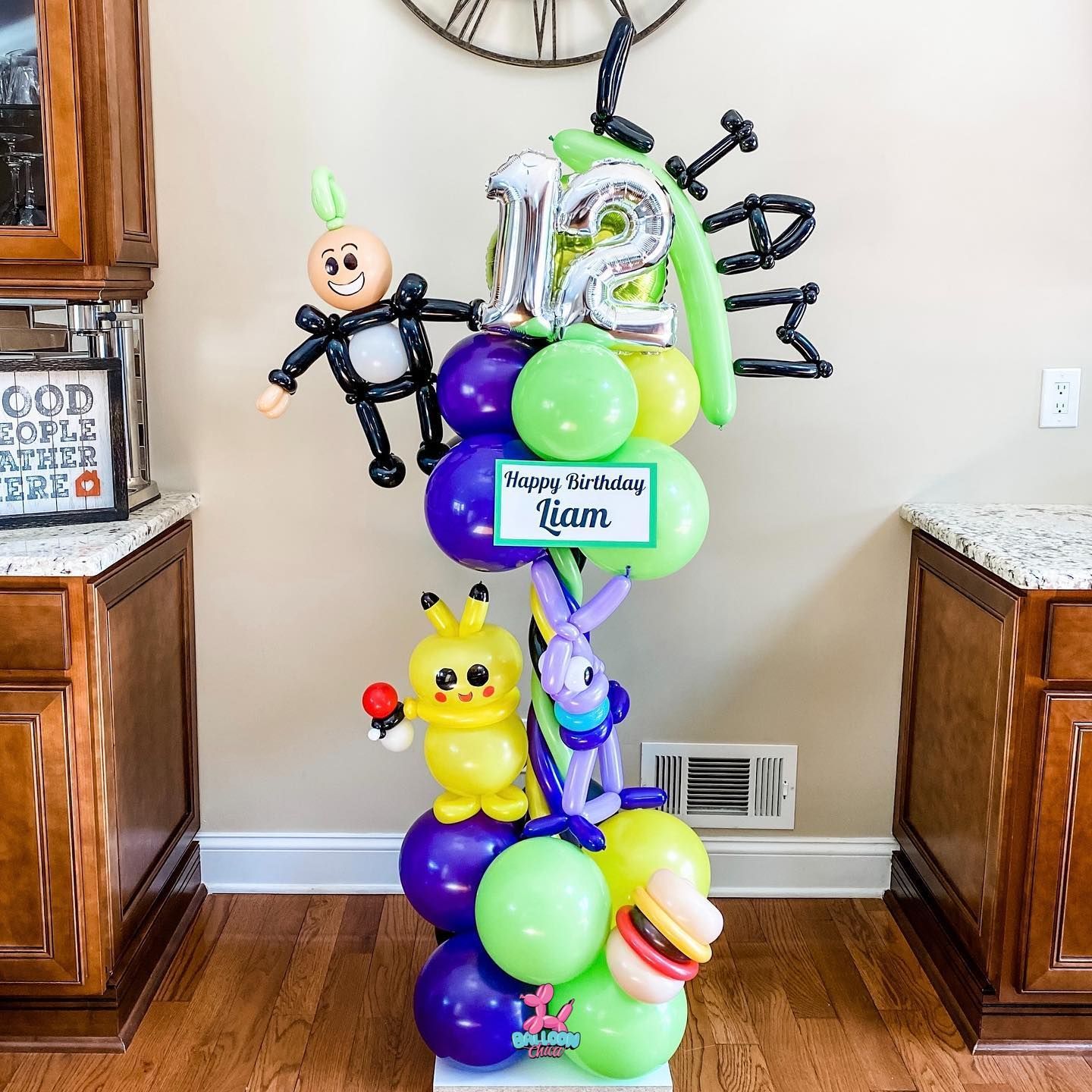 a bunch of balloons are stacked on top of each other in a room