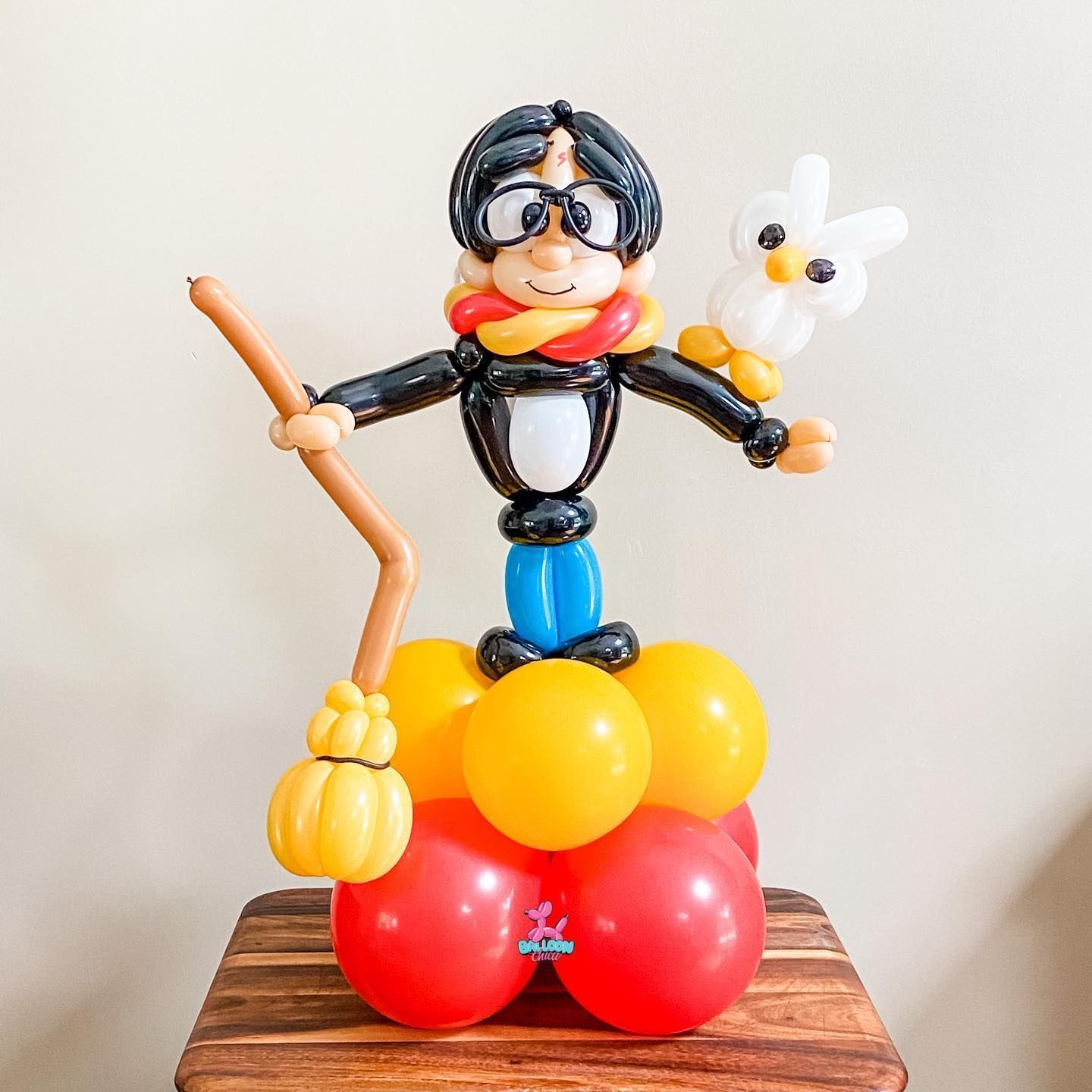 a balloon sculpture of harry potter is sitting on a wooden table
