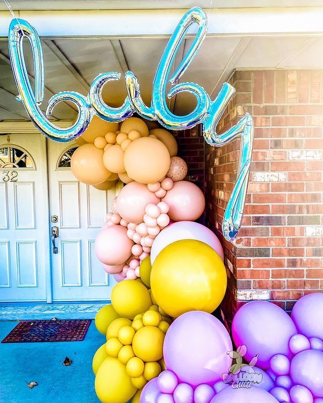 a bunch of balloons are sitting in front of a brick building