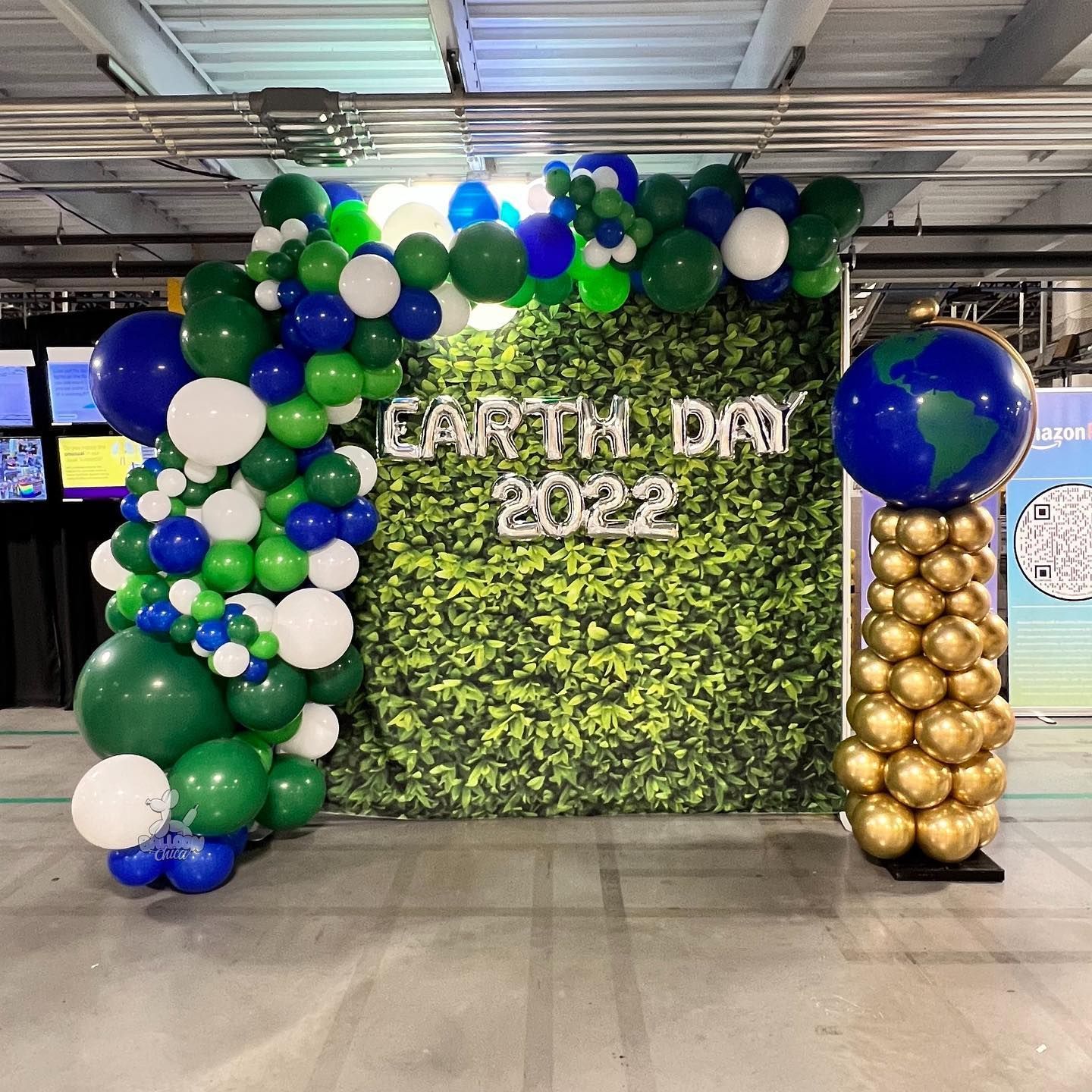 a wall decorated with balloons for earth day 2022