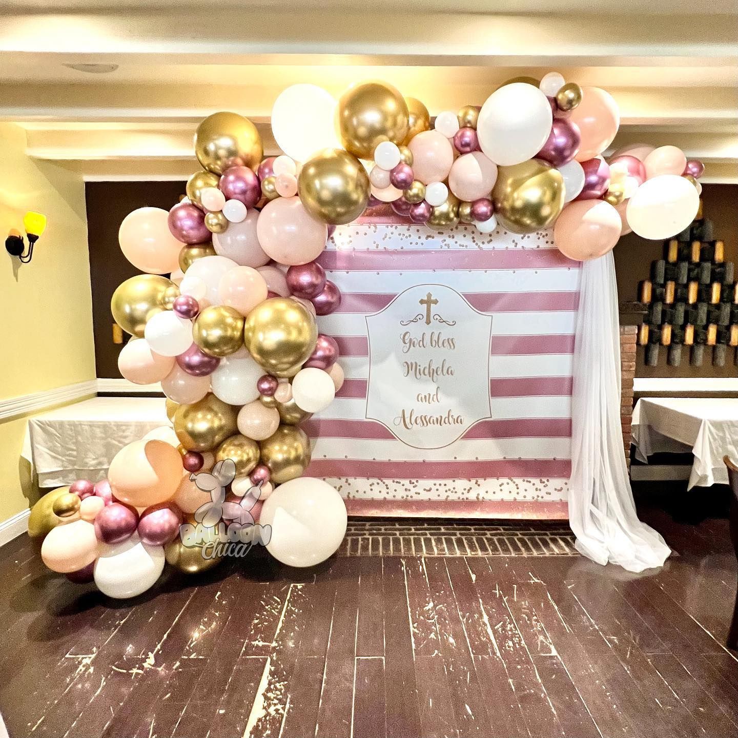a room filled with balloons and a striped backdrop .