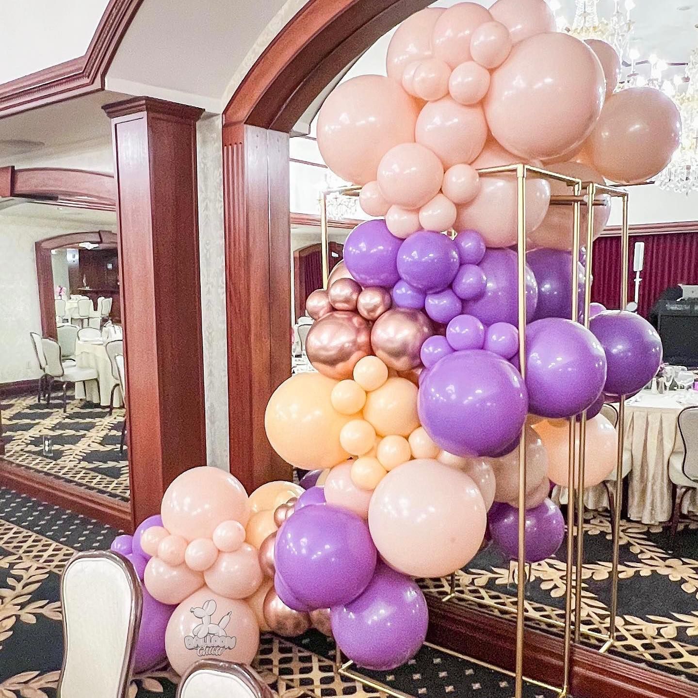 a bunch of balloons are stacked on top of each other in a room