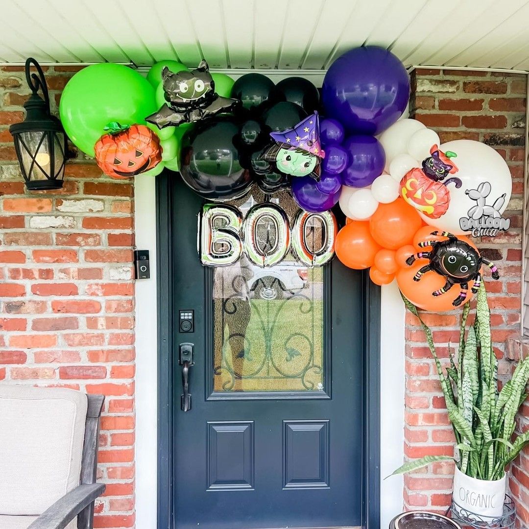 a door decorated with halloween balloons and a boo sign
