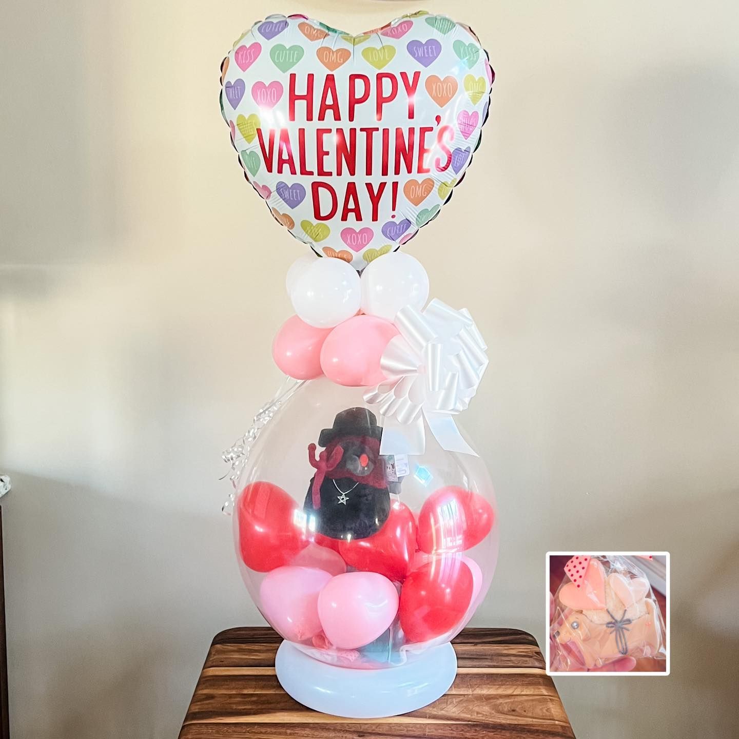 a balloon filled with hearts and a balloon that says happy valentine 's day