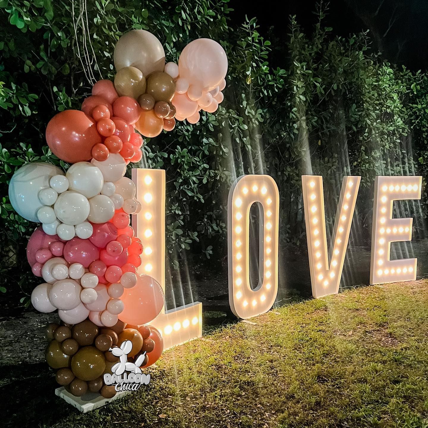 the word love is made of balloons and lights
