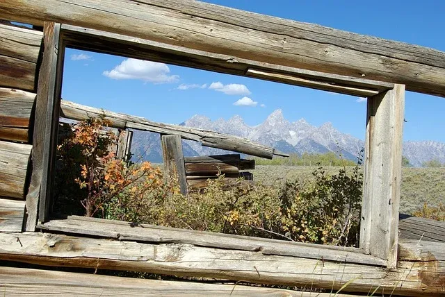 A wooden frame with a view of mountains in the background