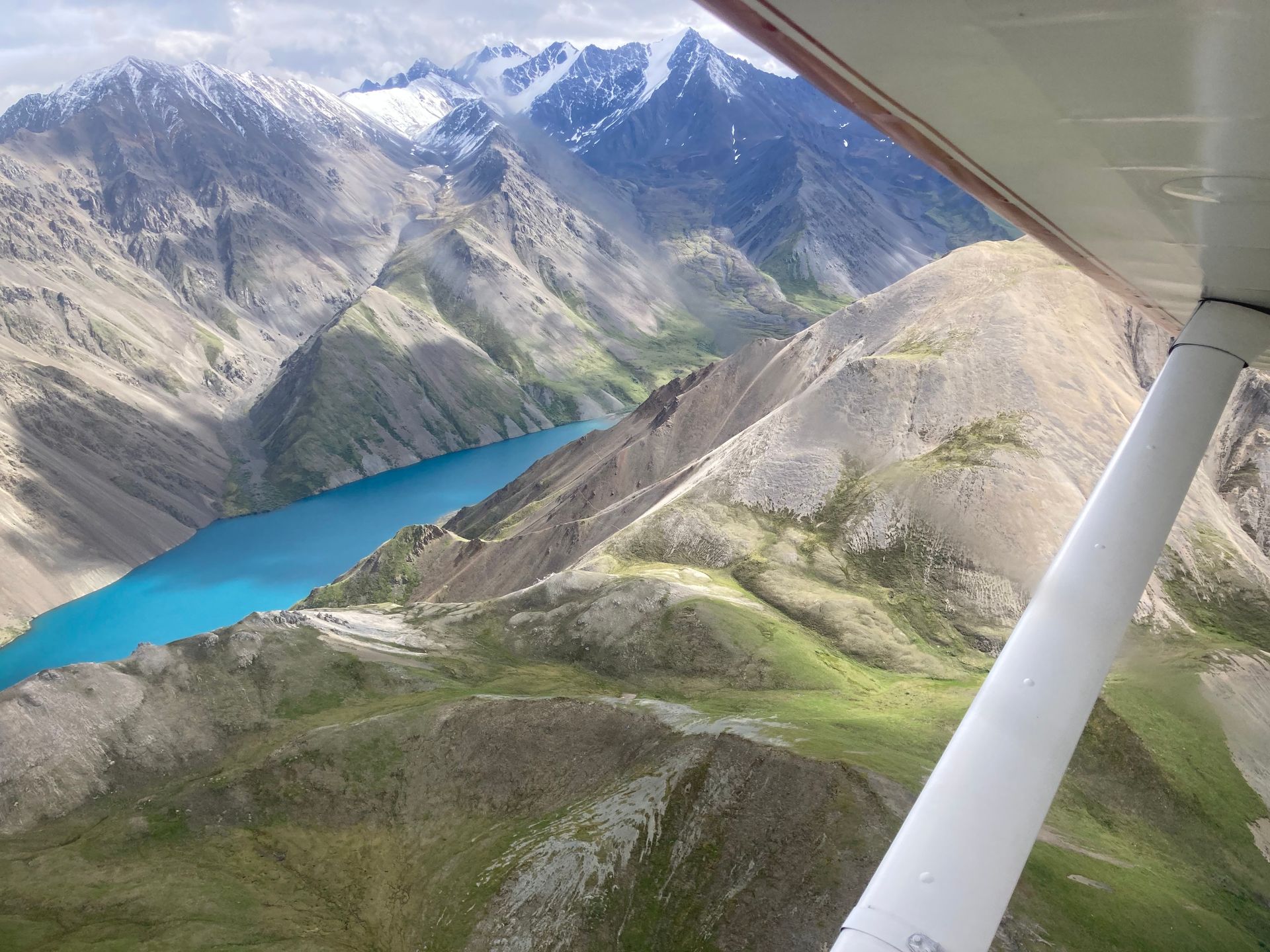 An aerial view of a lake surrounded by mountains