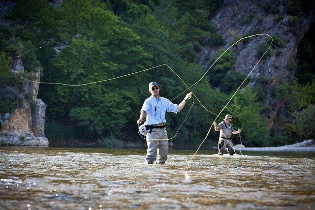 Two men are fly fishing in a river.