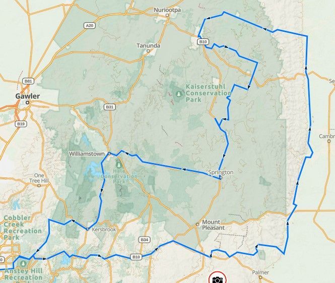 Map with a blue outlined route around a green park area near Sacramento.