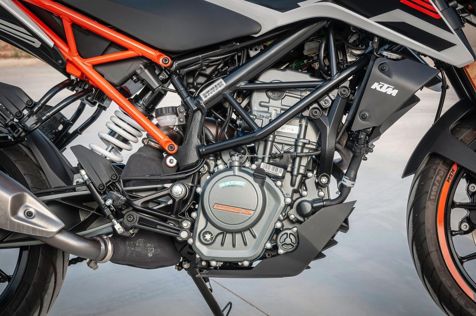 Close-up of a black and orange KTM motorcycle engine and frame.