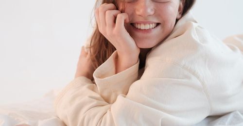 A close up of young girl smiling, wrapped up in a bathrobe