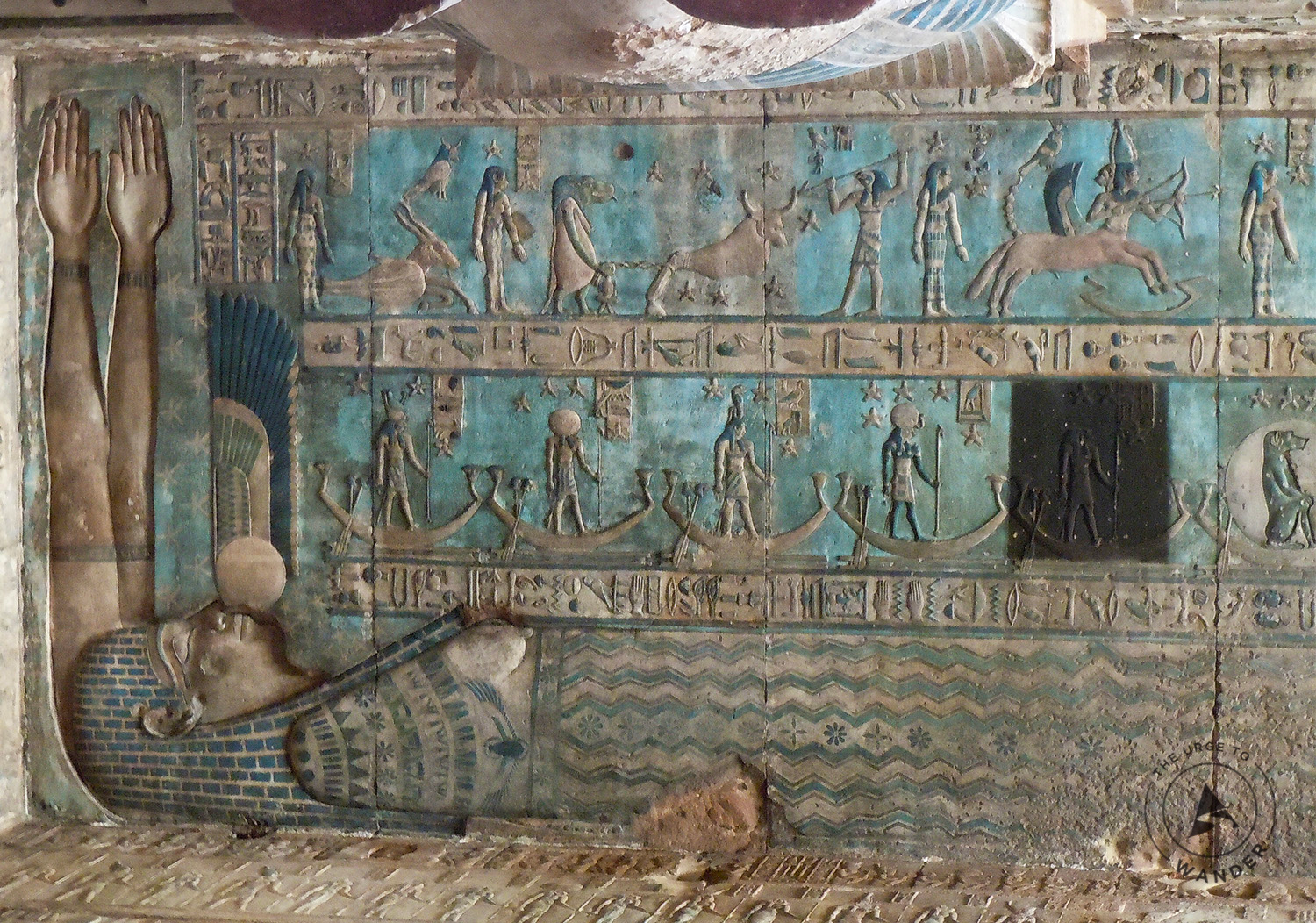 Ancient Egyptian wall painting of a reclining pharaoh with figures, boats, and blue decorative bands