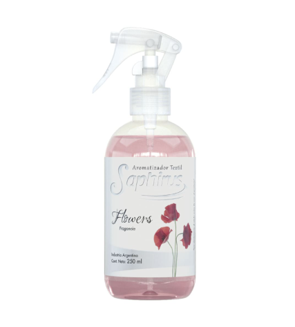 Botella de ambientador rosa con estampado floral, boquilla blanca y etiqueta de flor.