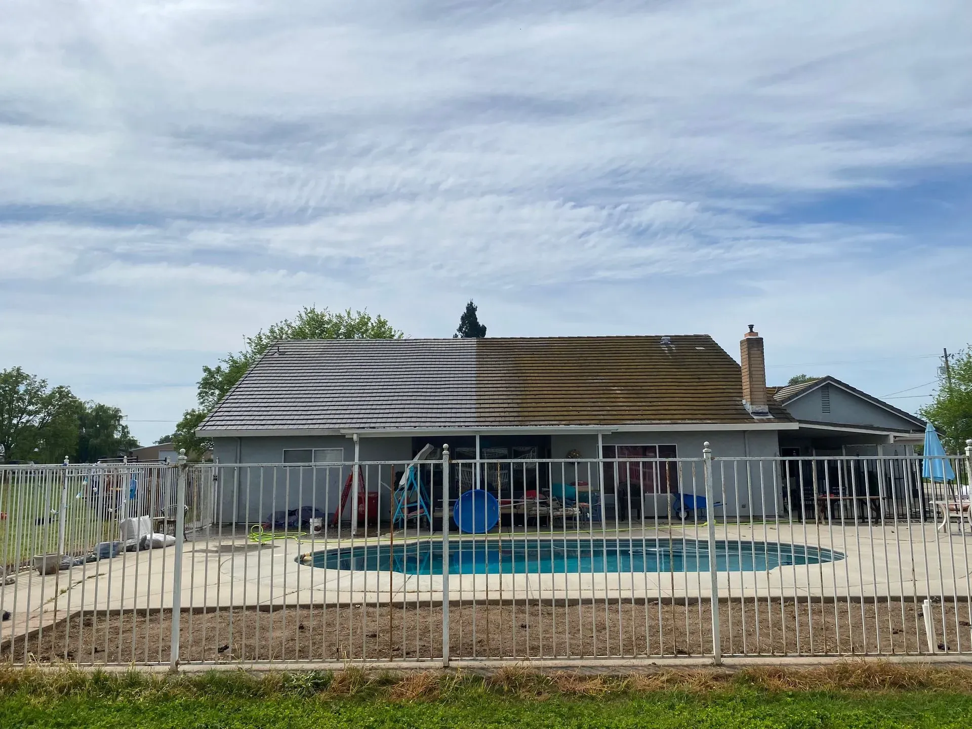 A house with a pool and a fence around it
