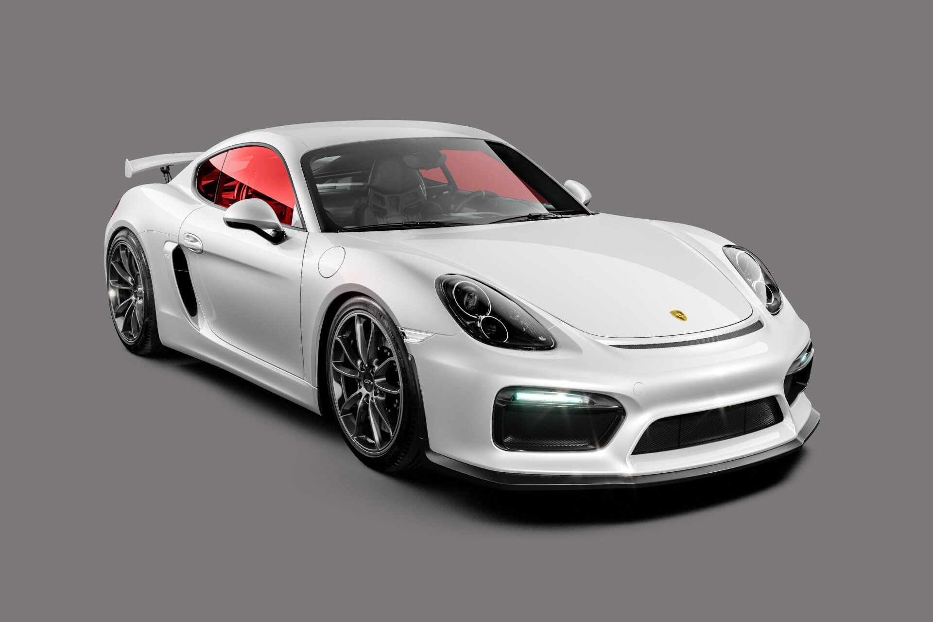 White Porsche sports car with red-tinted windows and black rims, set against a gray background.