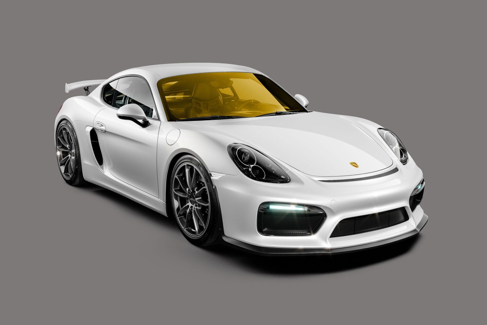 White Porsche sports car with tinted yellow windshield, angled on a gray background.
