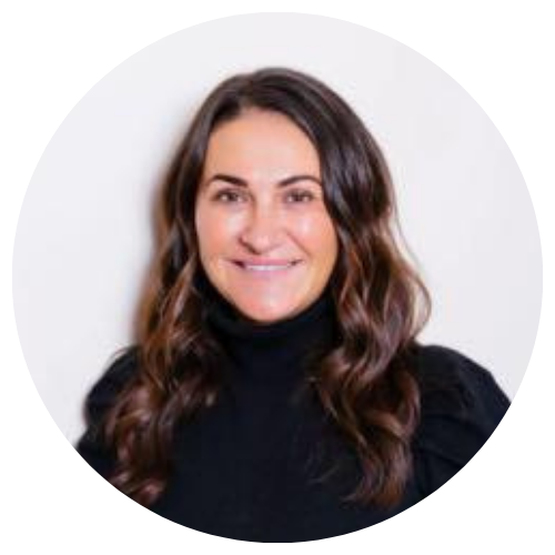 Portrait of a smiling woman with long brown hair wearing a black turtleneck on a white background