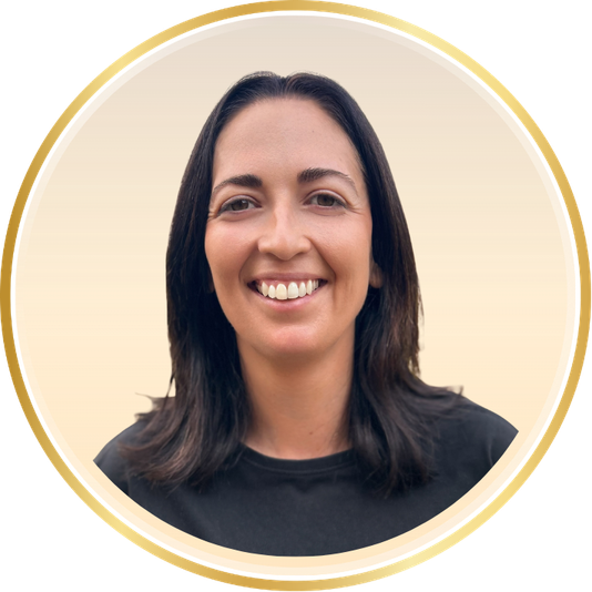 Smiling person with dark hair in a black shirt, centered in a circular gold border on a light background