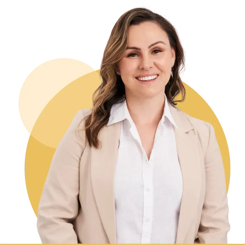 Smiling professional in beige blazer and white shirt against a yellow circular background