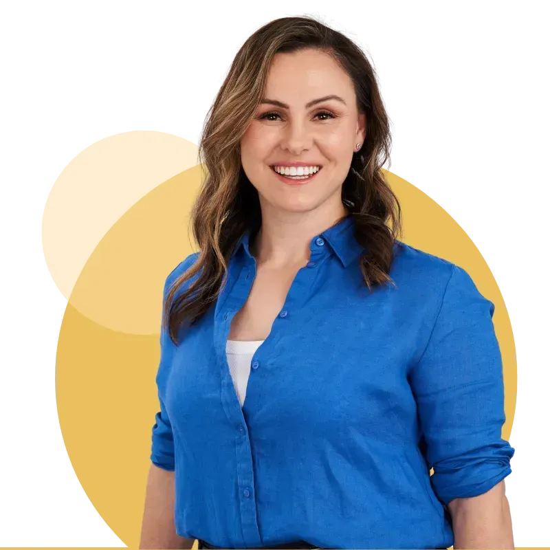Smiling woman in a blue shirt against a light yellow circular background