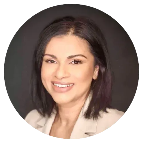 Portrait of a smiling woman with dark hair against a dark background