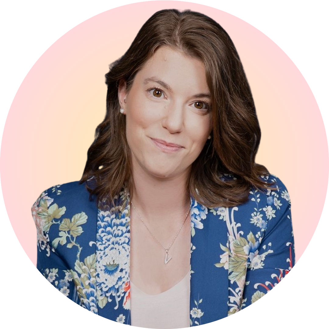 Portrait of a smiling woman in a blue floral blazer against a soft pink circular background