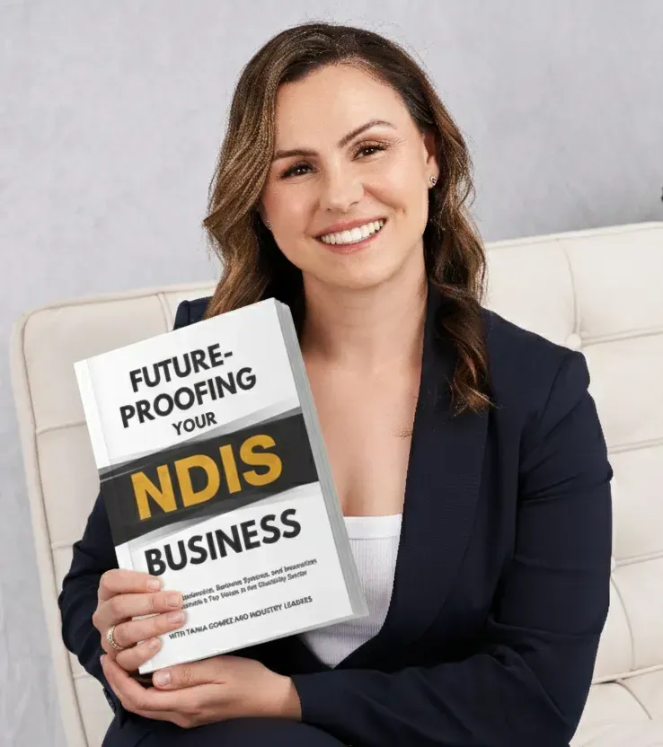 Woman smiling on a couch, holding a booklet titled “Future-proofing your NDIS business.”