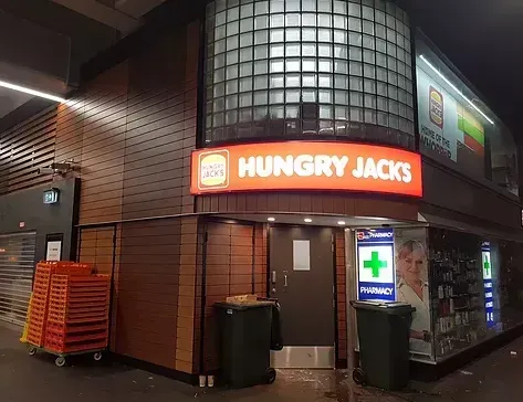 A building with a sign that says hungry jacks on it
