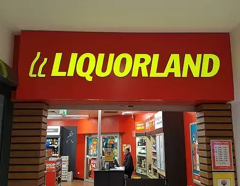 A liquorland store with a red and yellow sign