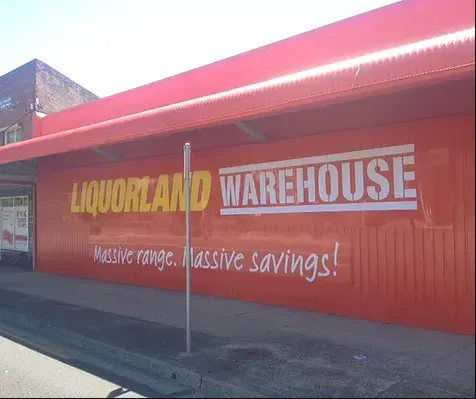 A liquorland warehouse store with a red awning