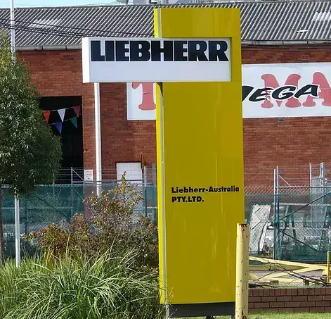 A large yellow sign that says liebherr on it