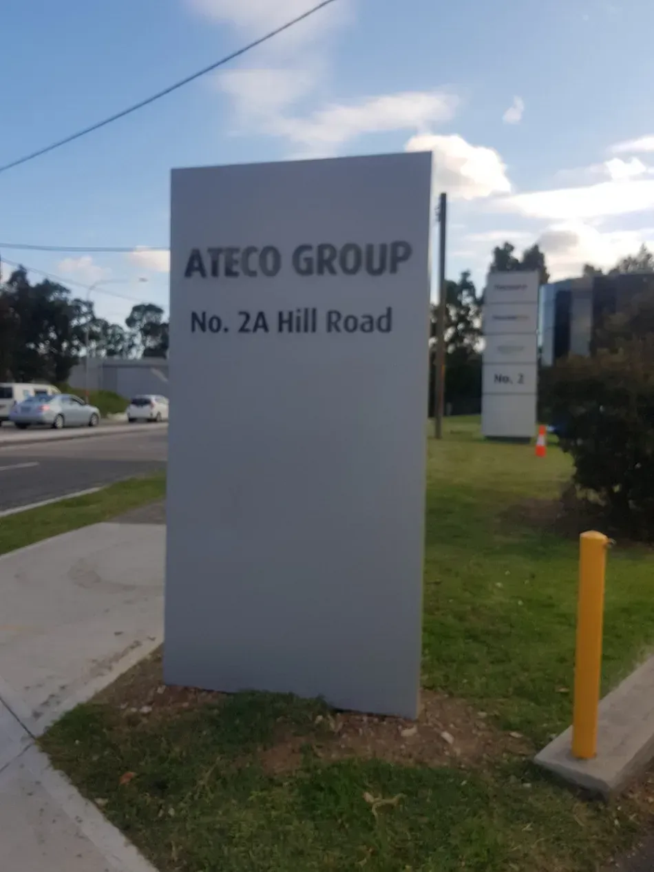 A white sign that says ateco group on it