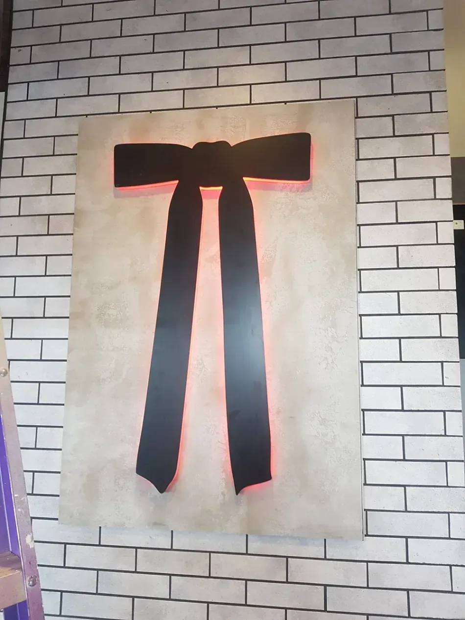 A white brick wall with a black bow on it