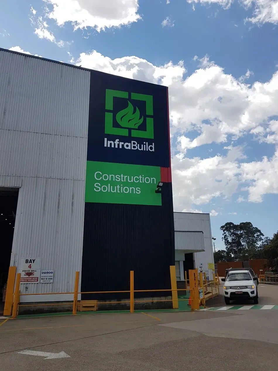 A building with a sign that says infrabuild construction solutions