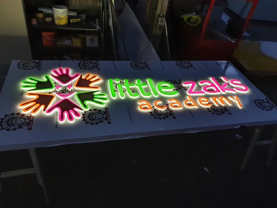 A neon sign that says little zak 's academy on it