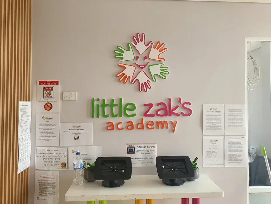 A little zak 's academy reception area with a clock on the wall.