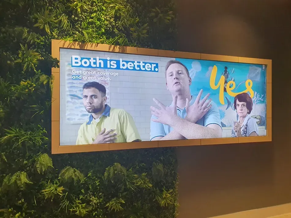 A billboard on a wall that says both is better