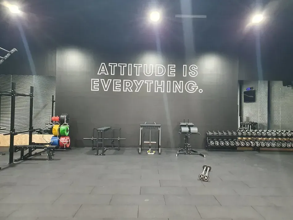 A gym with a sign on the wall that says