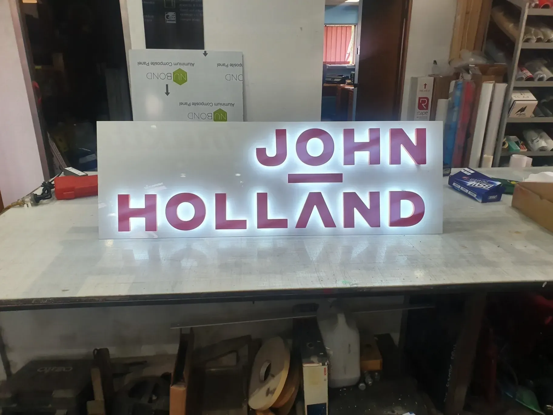 A sign that says john holland is on a table