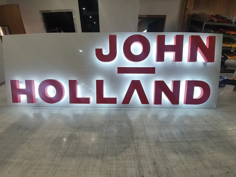 A sign that says john holland in red letters
