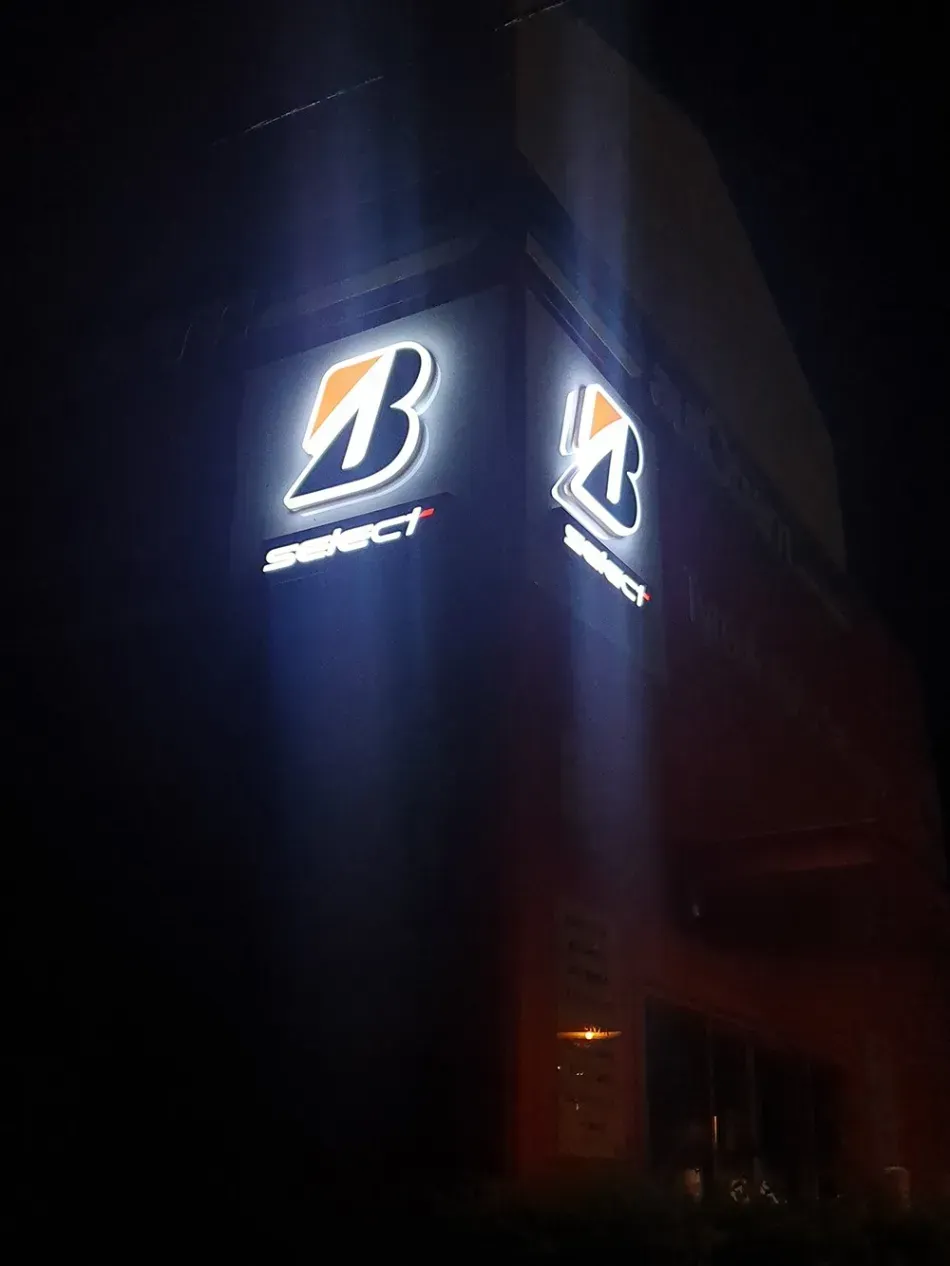 A bridgestone sign is lit up at night