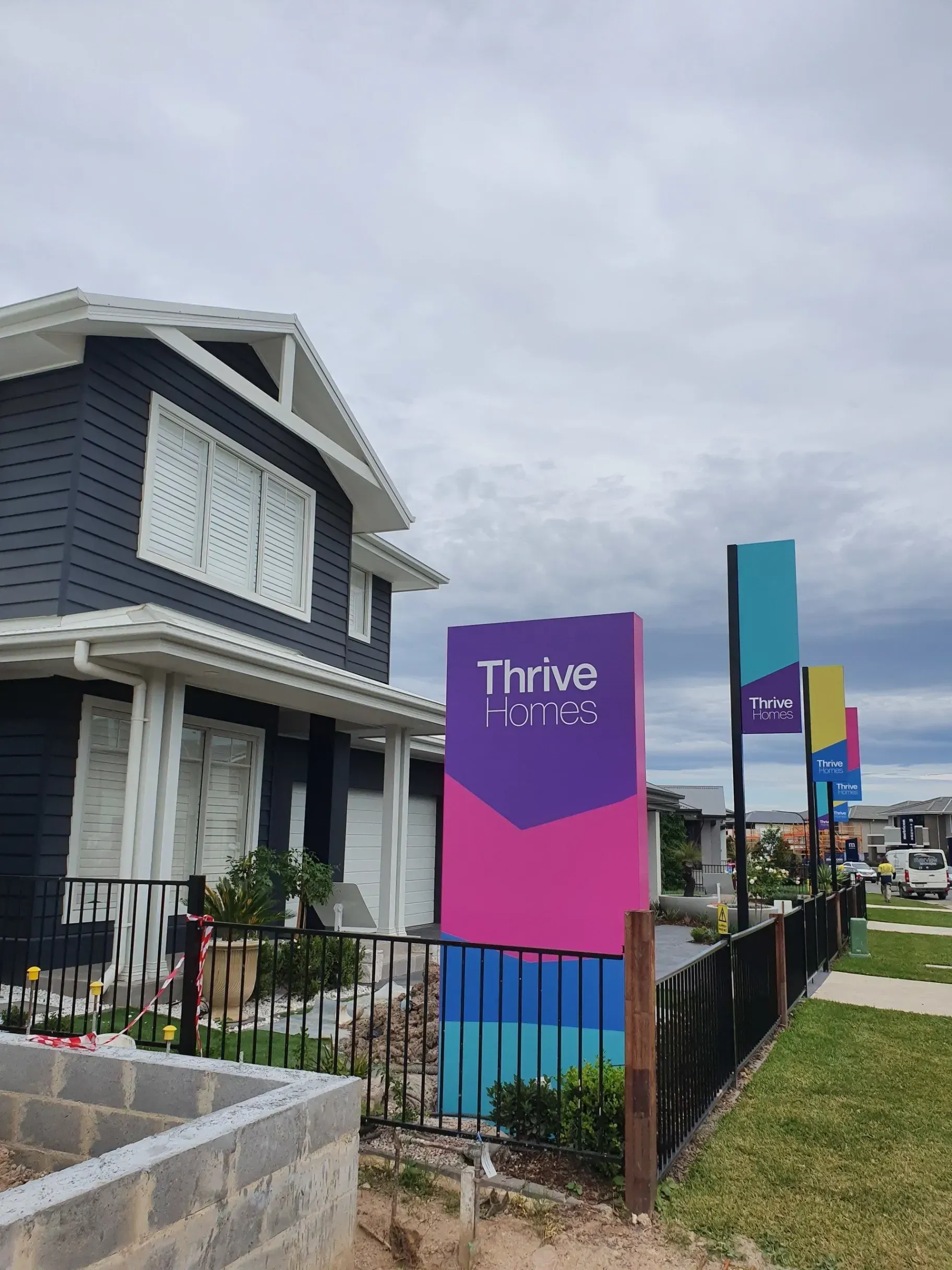 A house with a sign in front of it that says thrive on it.
