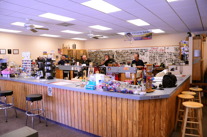 A group of people are working at a counter in a store
