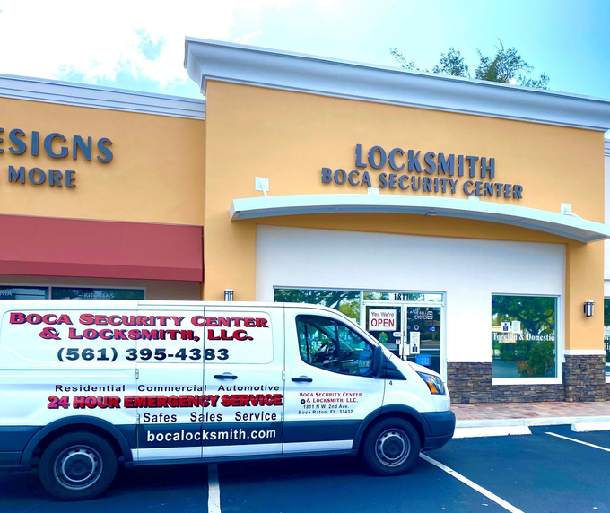 A locksmith van is parked in front of a building