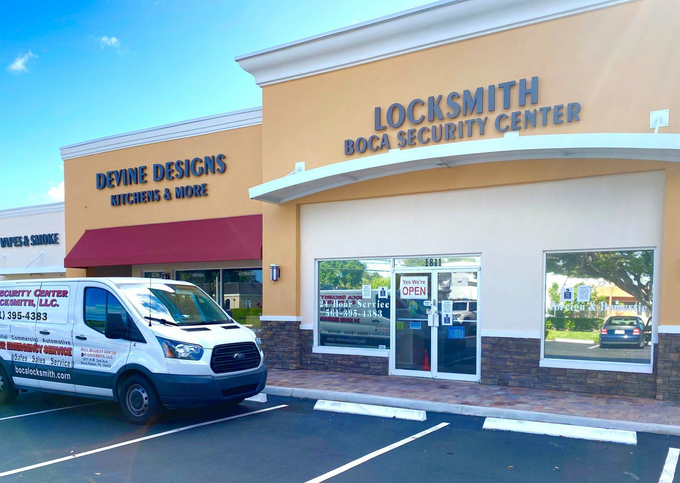 A white van is parked in front of a store called locksmith boca security center