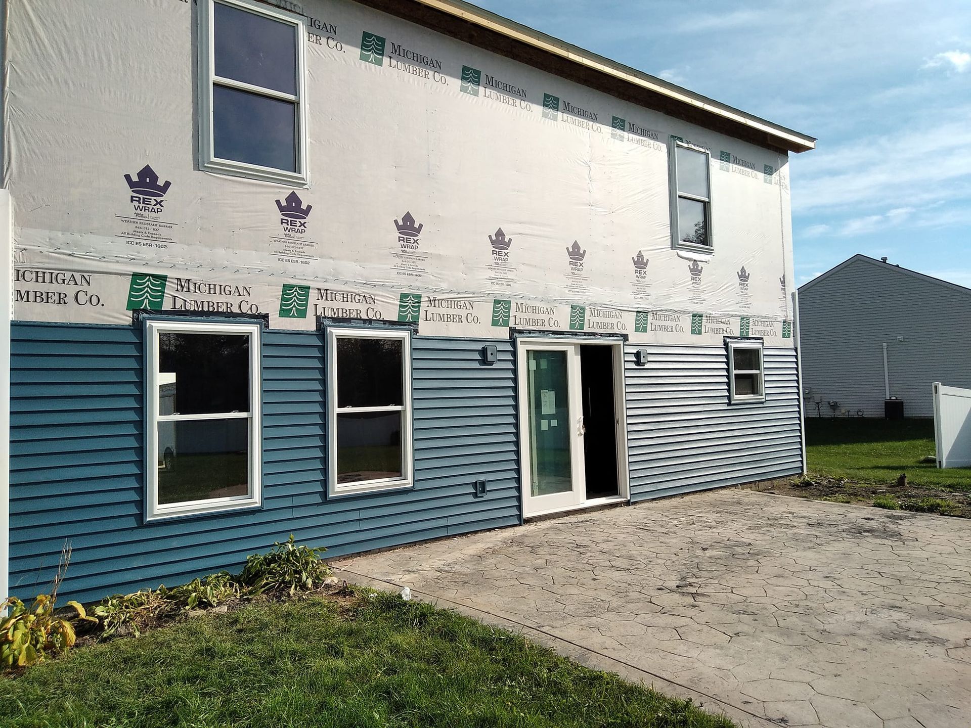 A house with a lot of windows and siding on it