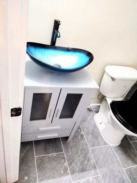 Image of a finished bathroom remodel. you can see the vanity was replaced and new bathroom tile was installed. 