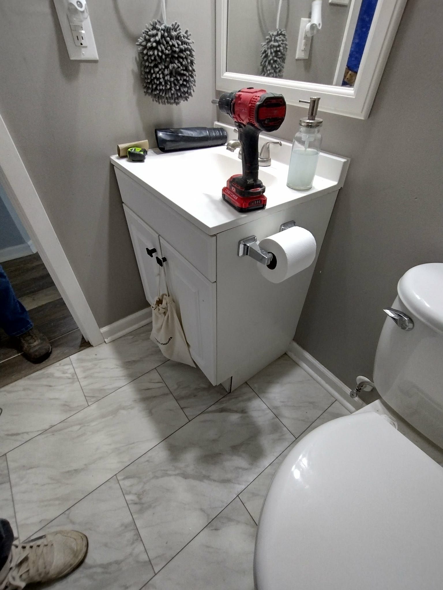 Image of a small bathroom remodeling being done by handyman. 